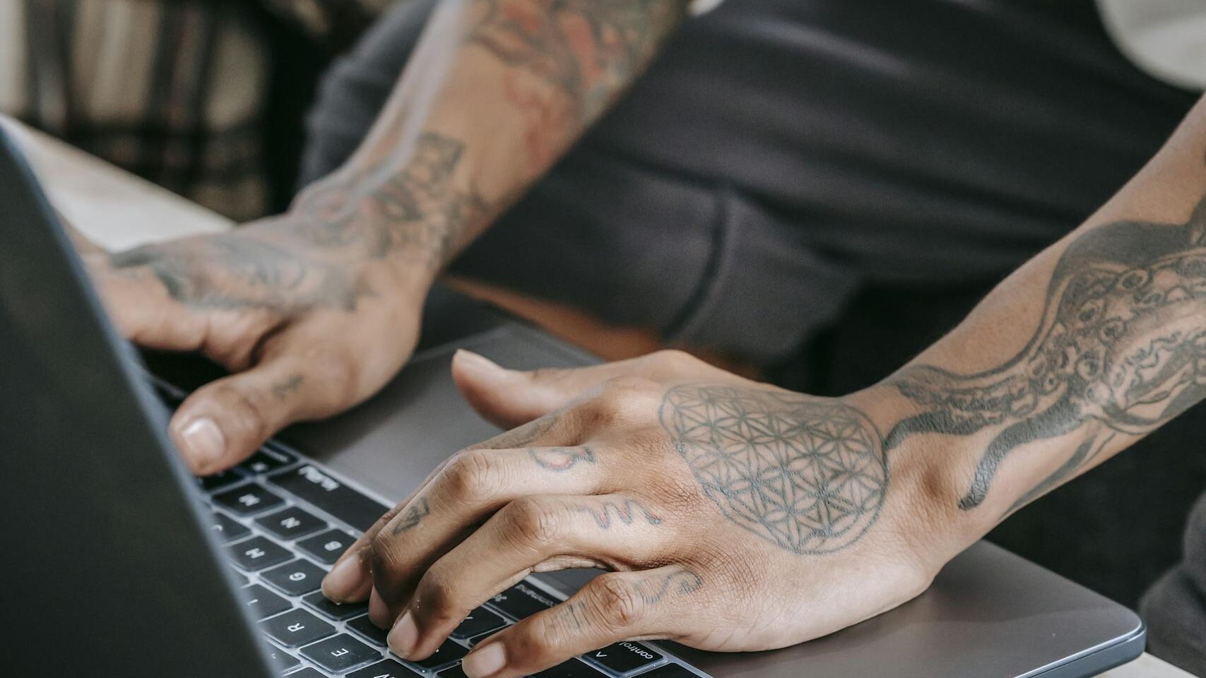 Crop person typing on laptop at home