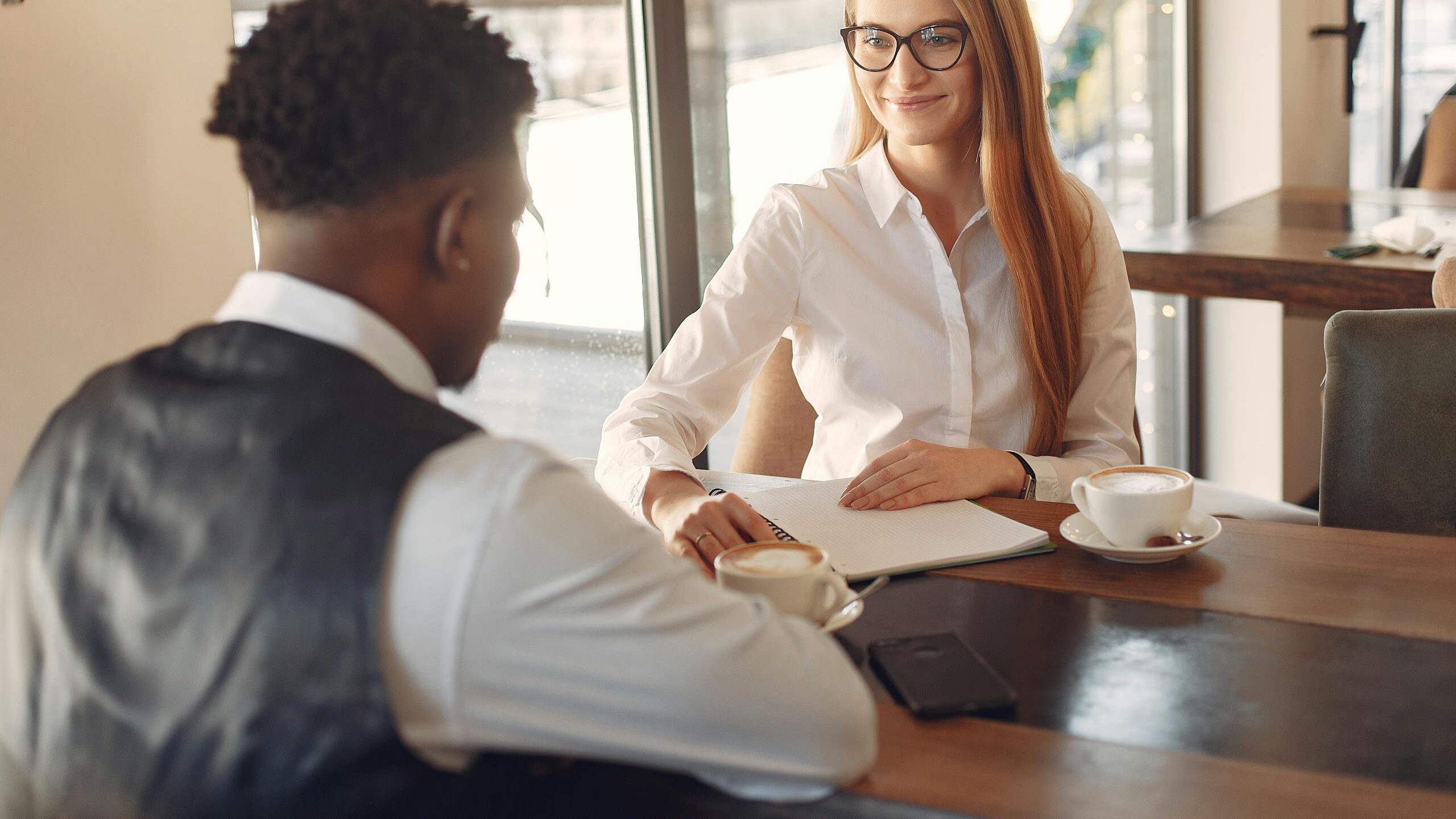 Man Being Interviewed By A Woman, checking career progression opportunities
