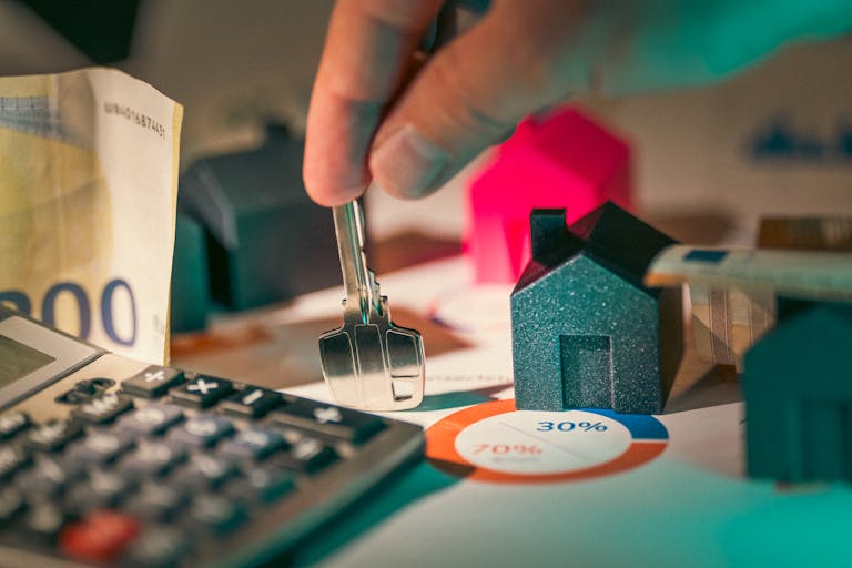 Housing investment prices. Hand holding key to new house door .