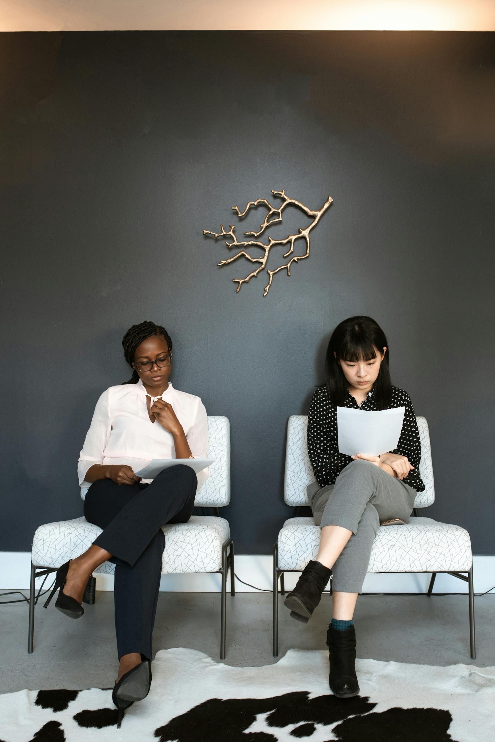 2 Women Sitting on White Couch